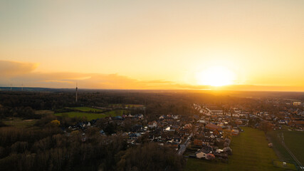 Aerial Sunset View over a Small Town Surrounded by Forest, Germany