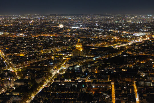 Aerial view of the golden dome of Les Invalides radiating light amidst the sprawling cityscape, Paris, Ile-de-France, France.