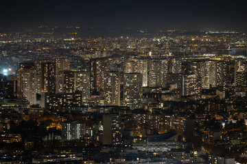 Aerial view of a cityscape bathed in a warm, dense glow of lights, illuminating the night in a mesmerizing display of urban energy, Paris, Ile-de-France, France.
