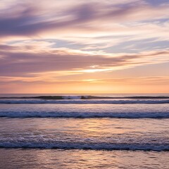 Obraz premium Beautiful sunset over the ocean with colorful sky and gentle waves creating a peaceful seaside scene