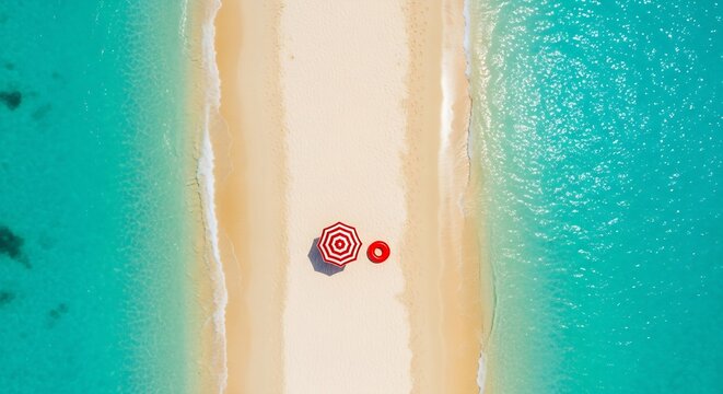 Aerial view of a red and white striped umbrella on a narrow tropical sandspit surrounded by turquoise ocean water.