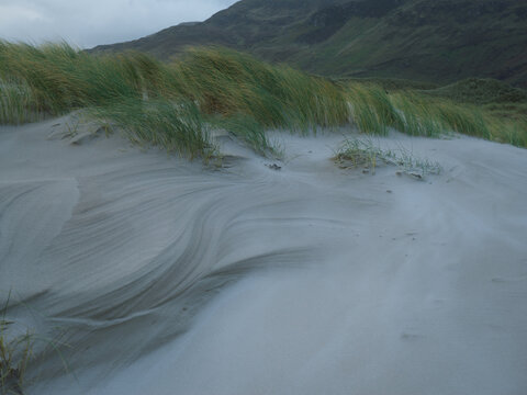Wind-Swept Dune Grass Against Rolling Hills at Maghera Beach Donegal Ireland