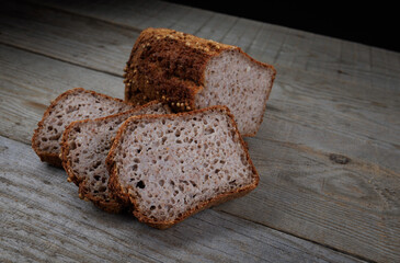 Sliced buckwheat bread on a light wooden background. Buckwheat bread with coriander.