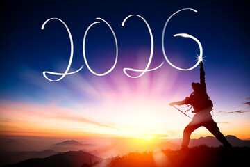 Silhouette of  young man  on the mountain while celebrating new year of 2026 at dusk time