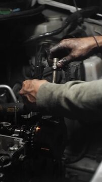 auto mechanic changing car engine