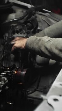 auto mechanic changing car engine