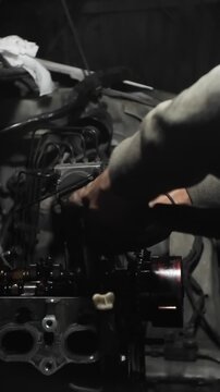 auto mechanic changing car engine