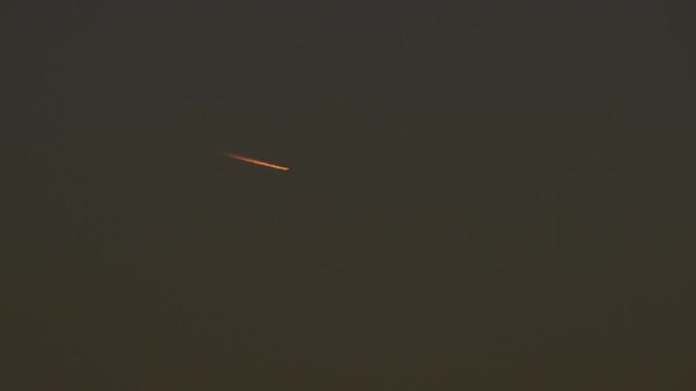Tokyo, Japan - November 17, 2025: Contrail or airplane track at dusk