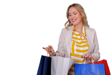 Happy woman enjoying successful shopping spree, holding colorful paper bags with purchases and smiling on transparent background