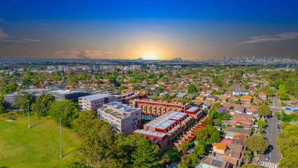 Fototapeta premium Aerial Panorama Drone View of a inner western Sydney Suburb of Ashbury Urban Sprawl and the terracotta roof tops streets and trees of Suburban Sydney NSW Australia