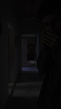 Man secretly calling lover in dark hallway and getting caught by girlfriend, Tense moment of betrayal and relationship conflict, vertical video