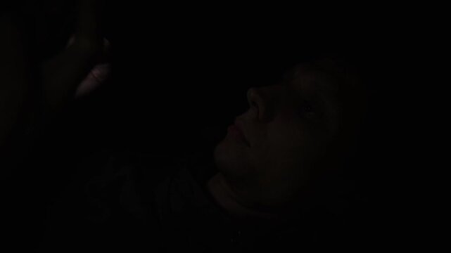 Man addicted to smartphone at night, social media dependence, compulsive scrolling