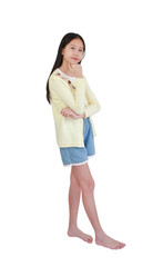 Young Asian girl stands barefoot, wearing yellow cardigan and denim shorts, posing in pensive...