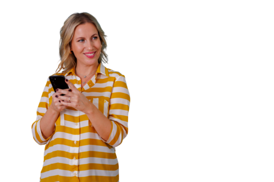 Happy blonde woman looking away while holding smartphone, smiling and thinking about social media content, transparent background