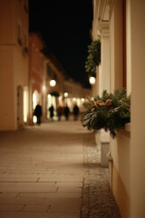 american city adorned with festive christmas banners and twinkling garlands illuminates streets during holiday