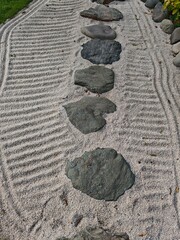 abstract view of a stone path stretching across the sand
