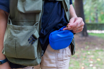 Professional dog walker preparing treats for training