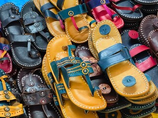Colorful Handmade chappals (sandals) being sold in an Indian market, Handmade leather slippers,...