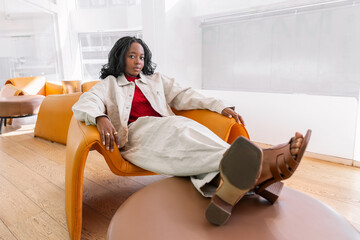 Relaxed young woman lounging in a modern setting