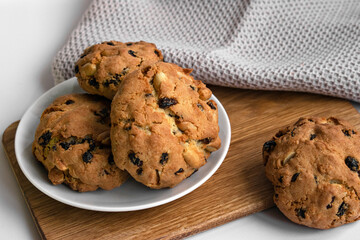 Cookies packed with nuts and raisins on wooden board. Ideal for food blogs, bakery ads and recipe. Homemade baked goods.