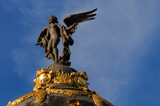 Metropolis building angel sculpture against blue sky