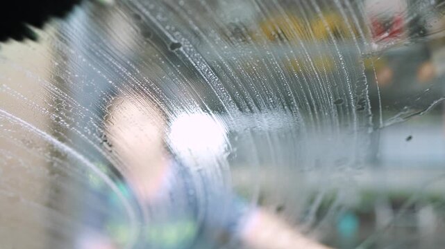 car wash, wiping the windshield with a cloth, showing careful car cleaning, maintenance, and professional car wash service