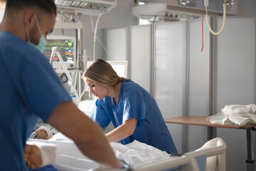 Professor mentoring nursing student in intensive care unit