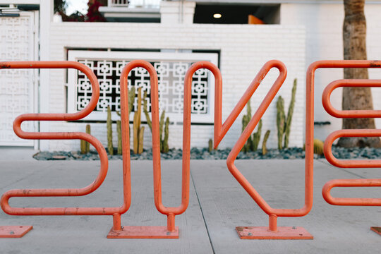 Orange bike rack in front of a retro-style motel