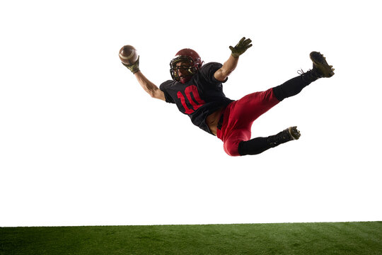 American football player diving horizontally with energetic emotion isolated on white background. Concept of dynamic action, sport advertising, athlete performance visuals.