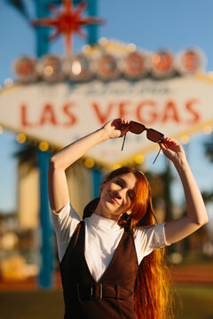 Young woman enjoying sunny day near Las Vegas sign
