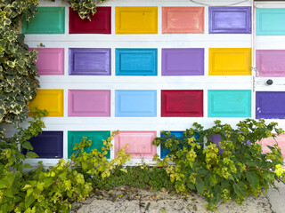 Old white door with vibrant colorful panels