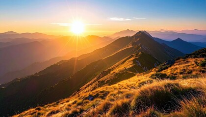 A breathtaking mountain landscape bathed in the warm glow of a rising sun, highlighting rugged peaks and golden grasses.
