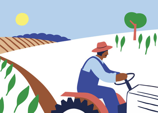 Farmer cultivating field on tractor under blue sky and bright sun