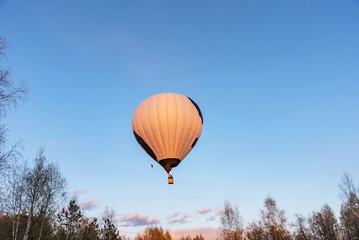 White with black hot air balloon in the sky. Beautiful balloon against a blue sky.