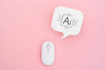 real white speech bubble paper cut with Ai icon and wireless computer mouse on pink background