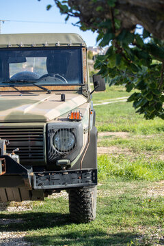 Camouflage military vehicle in a natural setting