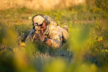 Camouflage sniper in airsoft training setting
