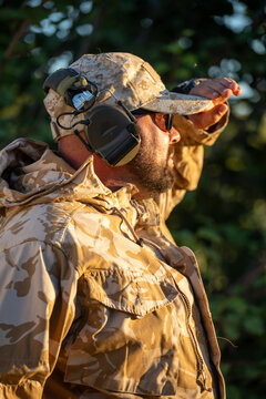 Tactical airsoft player in camouflage and headset