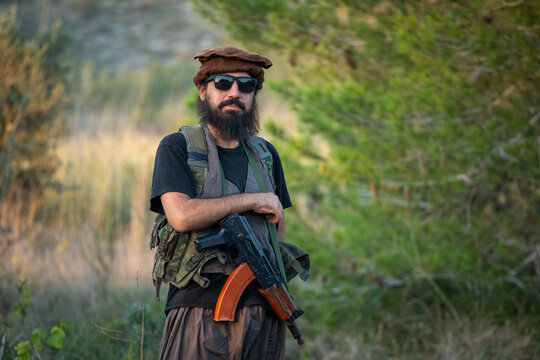 Man in military gear with airsoft gun outdoors