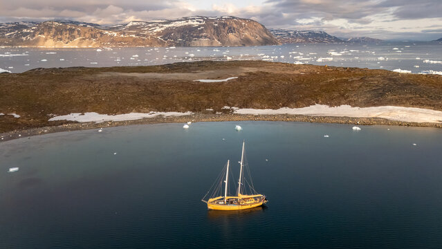 Midnight sun over serene Greenlandic waters