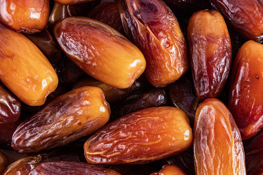 Close-up of glossy brown dates in a rustic arrangement