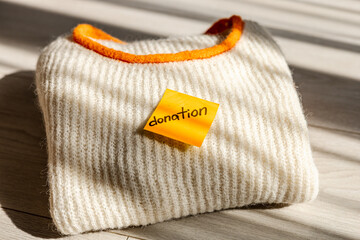 Donation concept with a cozy knitted sweater