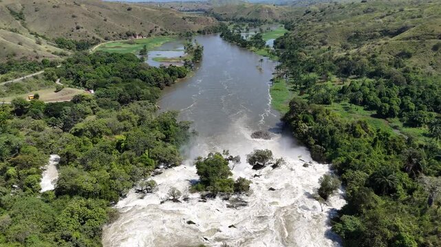 Drone footage showing the Kwanza River flowing toward the Binga Falls in Angola, where the calm surface turns into a powerful cascade through tropical forest