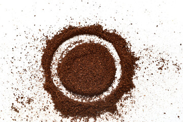 Ground black coffee is scattered on the table.