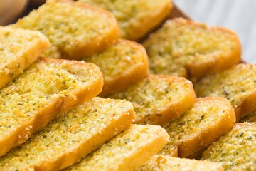Golden brown garlic bread slices stacked high