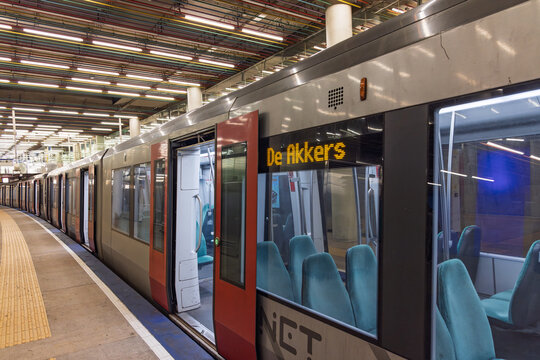 A Rotterdam metro train with open doors at Central Station. The destination sign reads 'De Akkers'. Turquoise seats are visible inside. Rotterdam Netherlands, 15 November 2025.