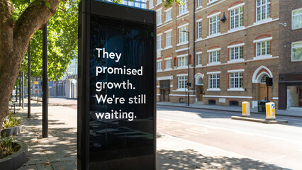 Street billboard with message reading They promised growth we&rsquo;re still waiting