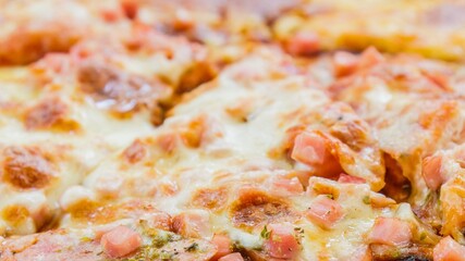 Close up of a delicious cheesy pizza with visible toppings