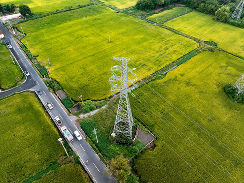 Sunset behind electricity pylons and green field. - Powered by Adobe