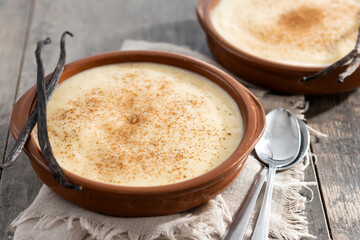 Creamy homemade Spanish custard served in a bowl on wooden table
